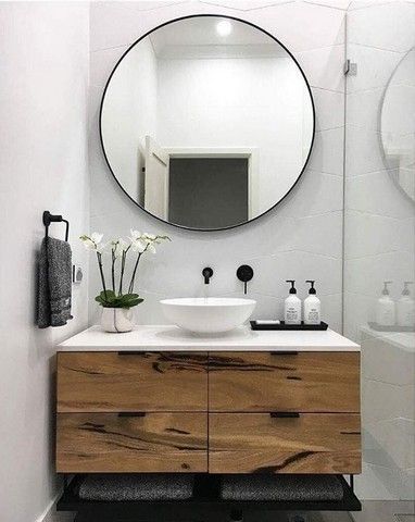 Black bathroom accessories with wooden vanity