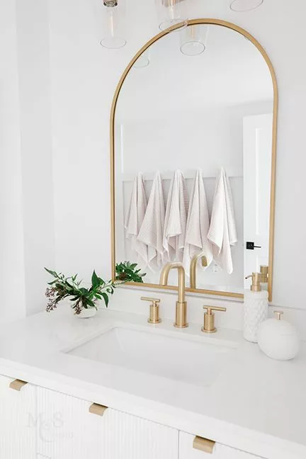 Gold framed mirror in bathroom