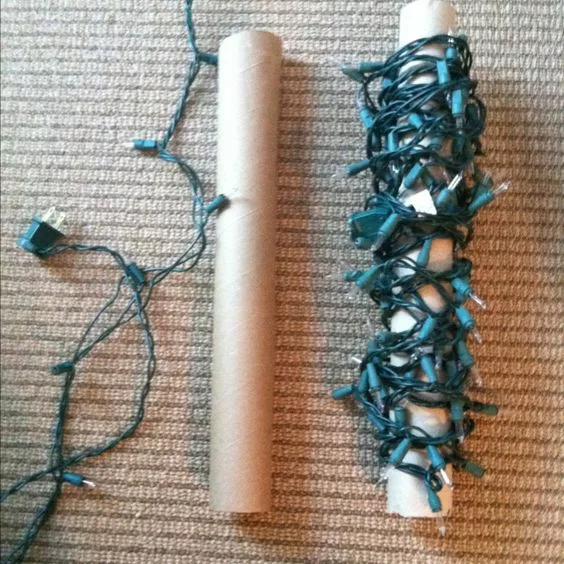 Christmas lights winded around paper rolls