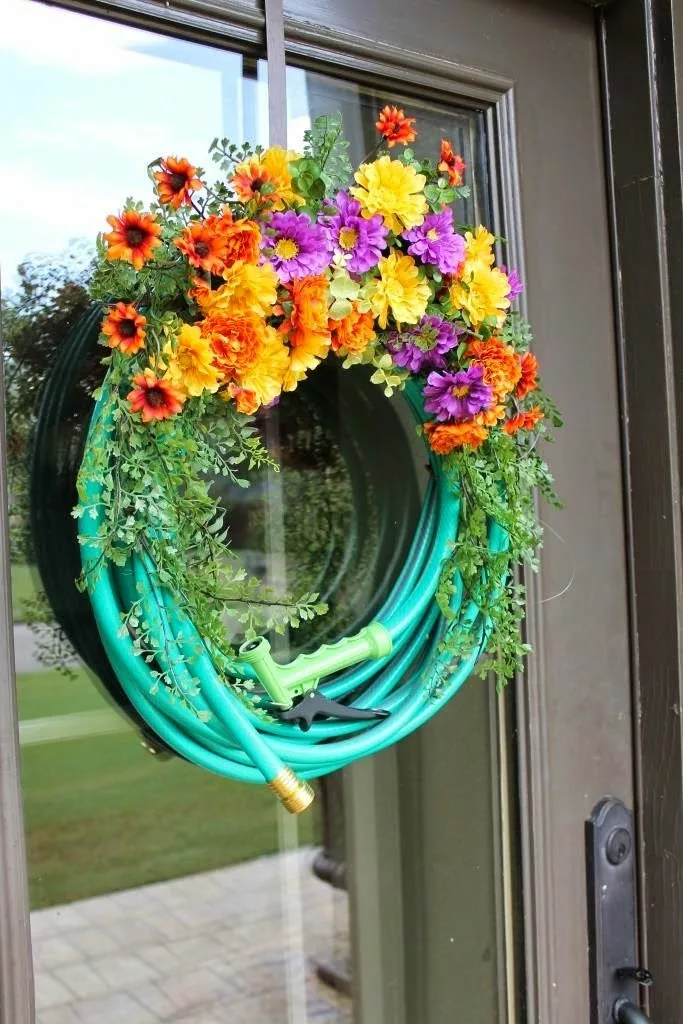 Garden hose as spring wreath on front door