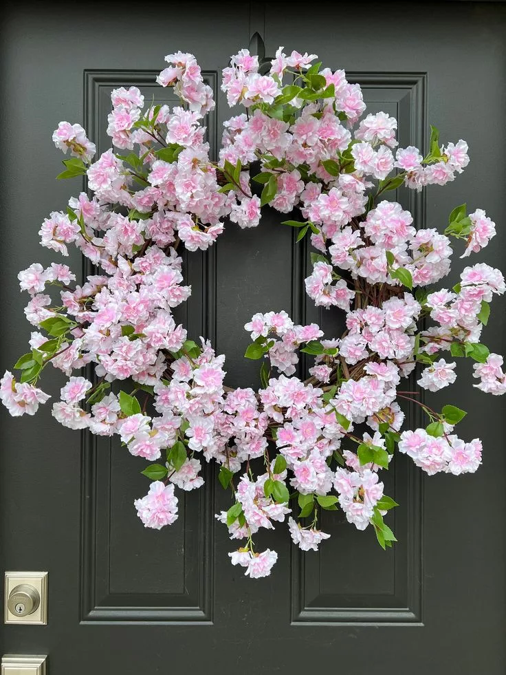 Pink cherry blossom wreath on front door