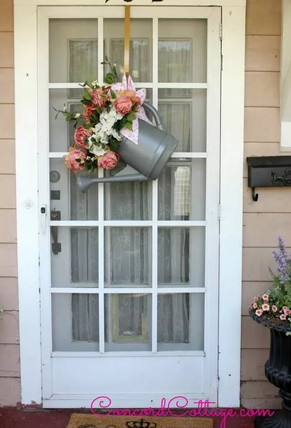 Watering can as front door spring decoration